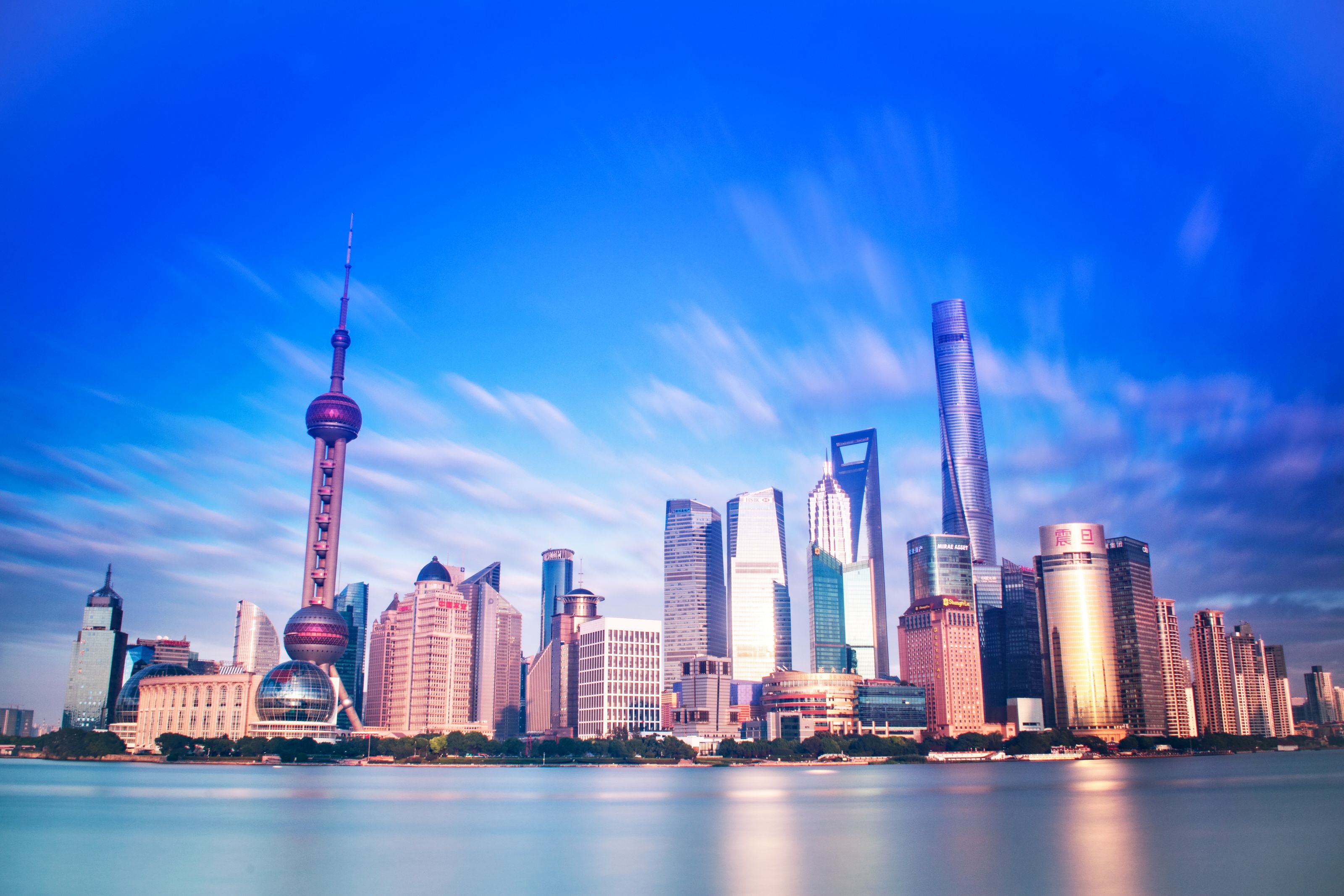 Vibrant Shanghai skyline featuring the iconic Oriental Pearl Tower and modern skyscrapers.