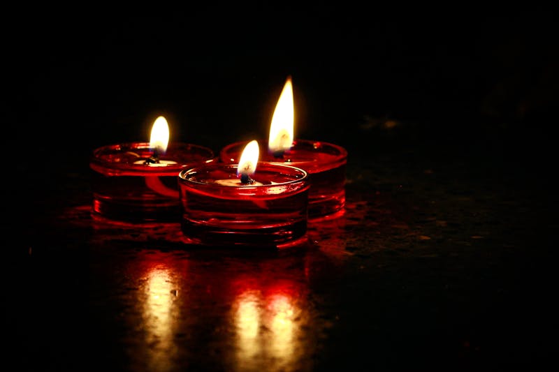 Warm candle flames glowing against dark background