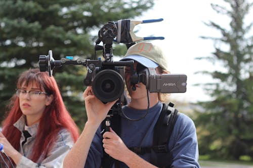 A Cameraman Recording On Outdoor Location