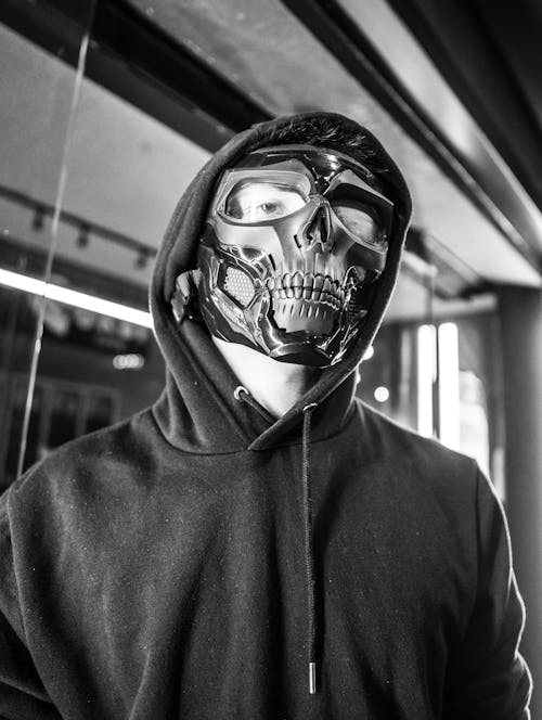 Person Wearing Black Hoodie and Black Skull Mask