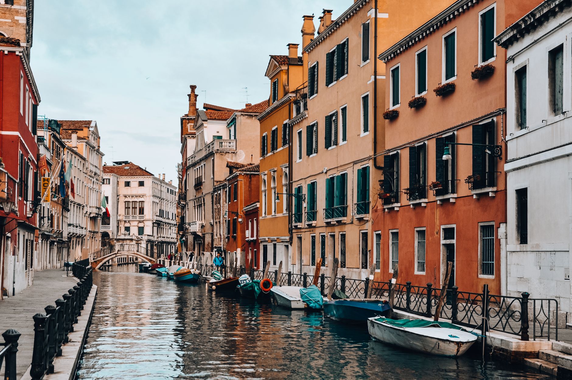 Picturesque view of Venetian canal with vibrant buildings and boats, capturing the essence of Italy.