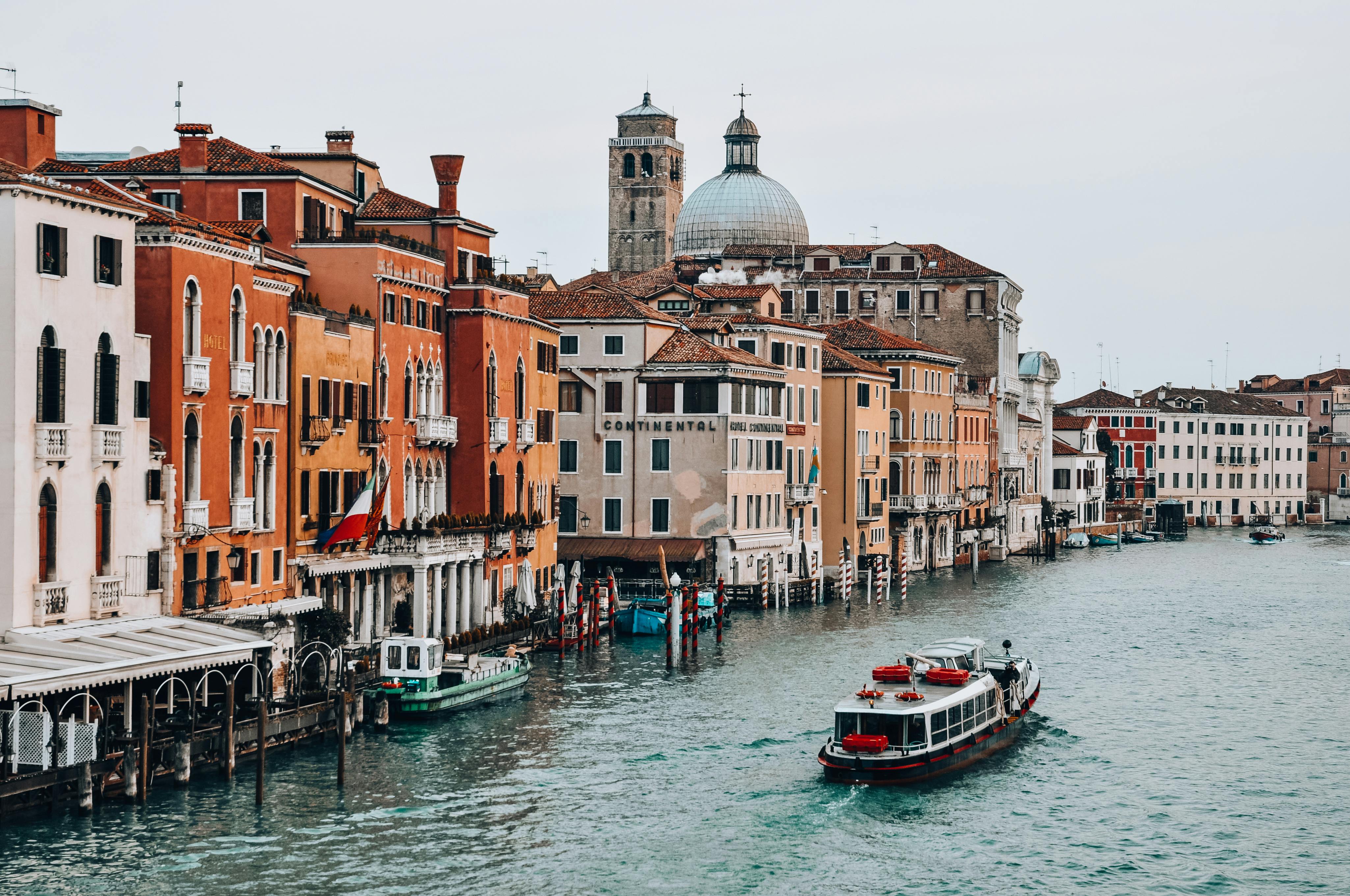 Free Scenic view of the Grand Canal in Venice with colorful old buildings and watercrafts. Stock Photo