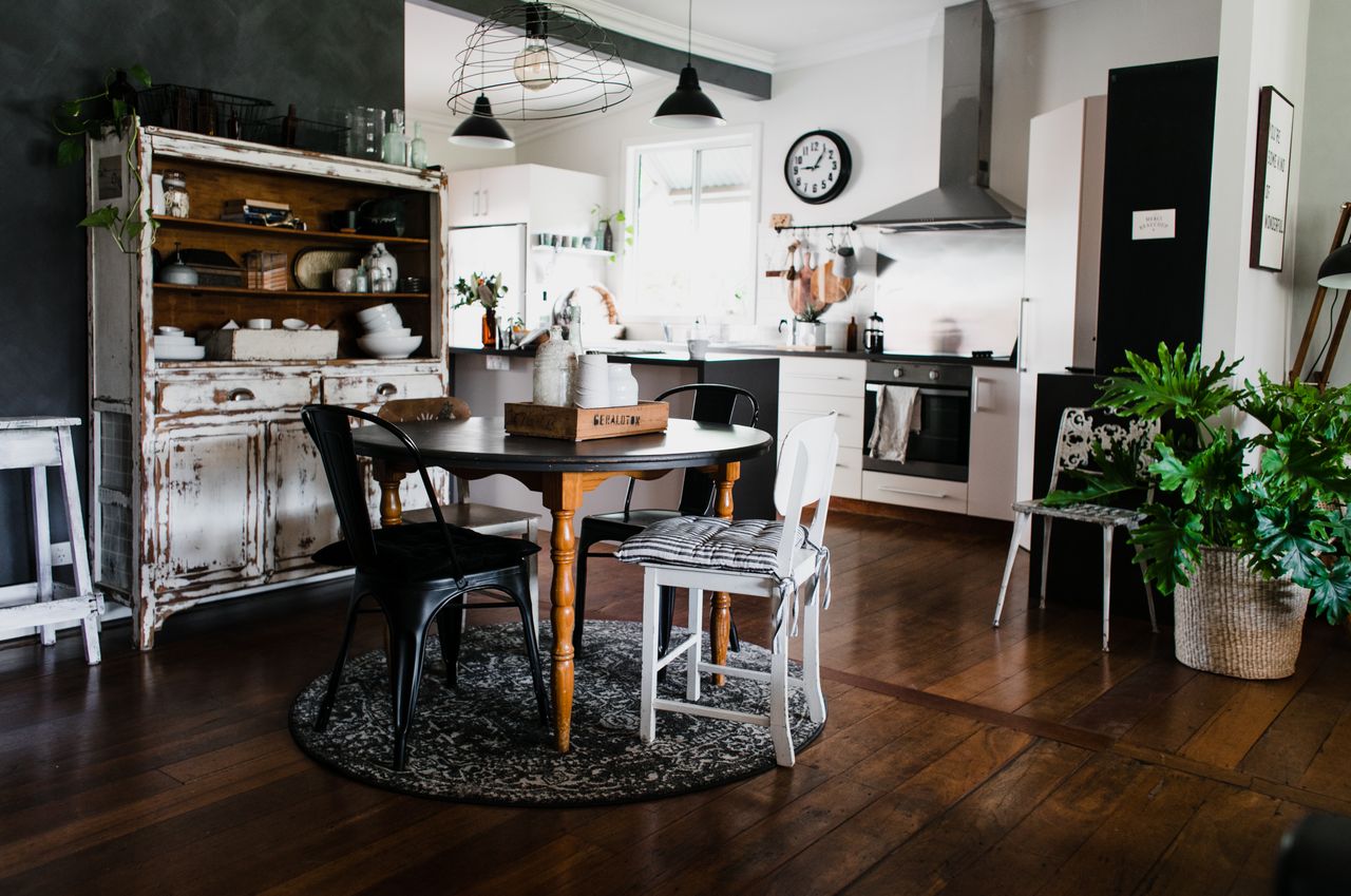 Round wooden table with chairs on an area rug