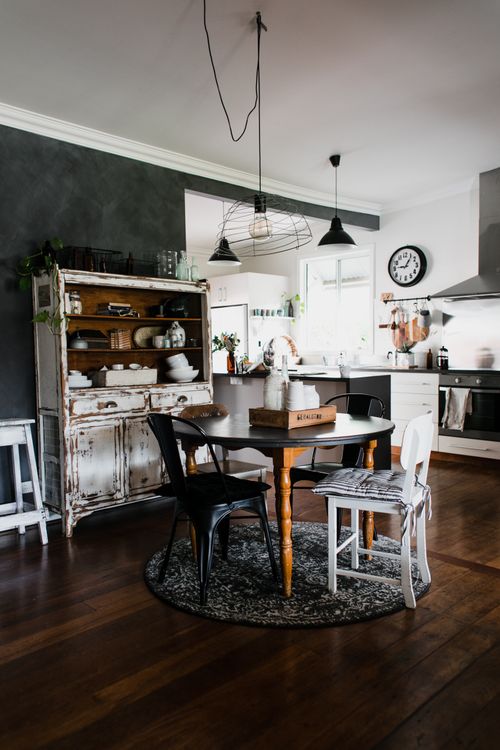 Free A cozy kitchen blending rustic and modern elements with vintage furniture and warm tones. Stock Photo