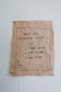 Brown Crumpled Paper With Message Posted On Wall