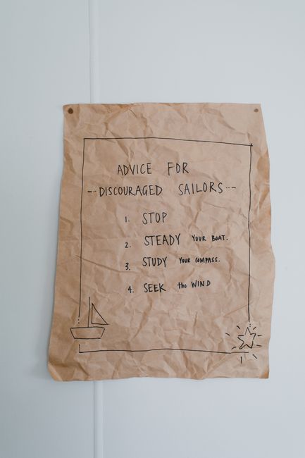 A handwritten note on crumpled paper giving motivational advice for sailors.