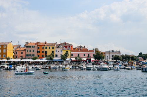 Free Scenic view of a vibrant coastal town with boats docked at the marina, perfect for travel inspiration. Stock Photo