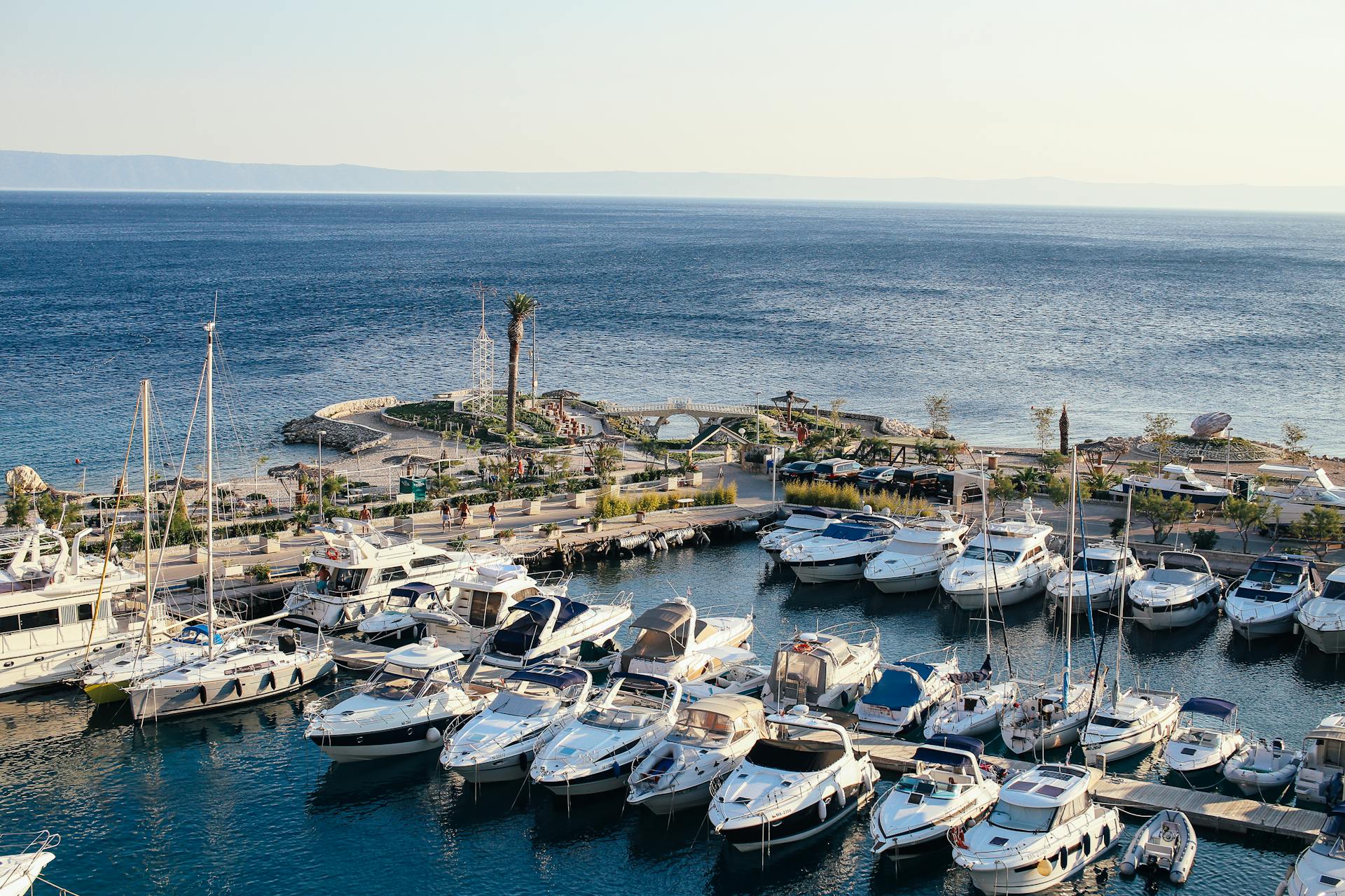 A picturesque view of yachts moored at a harbor along the Mediterranean coastline.