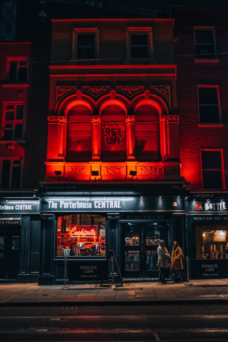 People Standing Outside A Bar