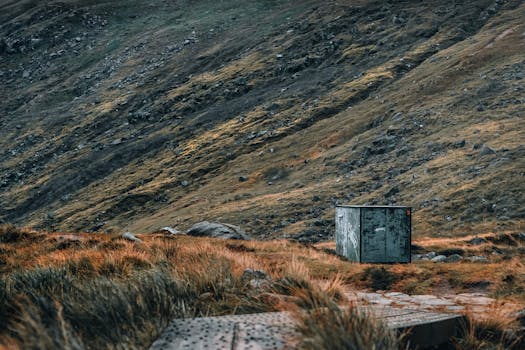 Scenic view of rugged terrain in Wicklow Mountains, Ireland, showcasing a weathered metal box amidst natural beauty.