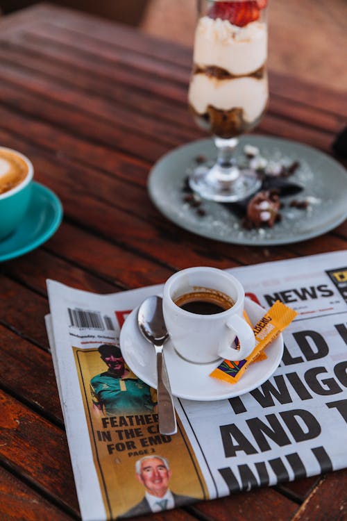 Free A Cup of Black Coffee over a Newspaper Stock Photo