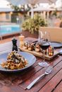 A Pasta Dish and a Glass of Red Wine on a Table