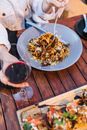 A Person Eating Pasta at a Dining Table