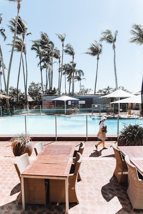 A Woman Walking Near the Pool 