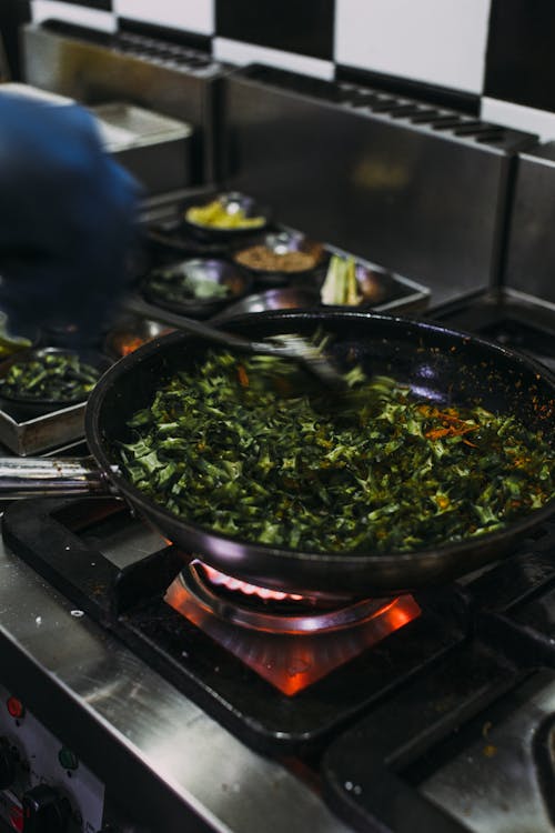 Free Cooking Vegetable Dish on Black Pan in a Stove Stock Photo