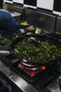 Cooking Vegetable Dish on Black Pan in a Stove