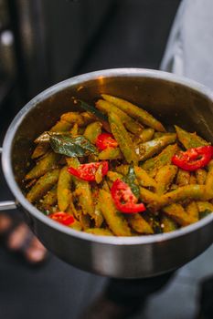 Delicious pasta with tomatoes and herbs cooked in a pan, perfect for a quick meal.