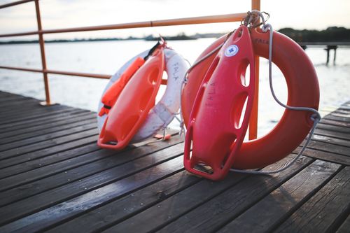 Free Close-up of lifebuoys and safety equipment on a lake dock providing serene waterside ambiance. Stock Photo