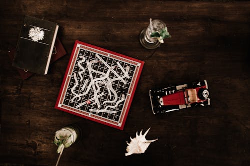 Overhead Shot of a Board Game and Cocktail Drinks on a Wooden Table 
