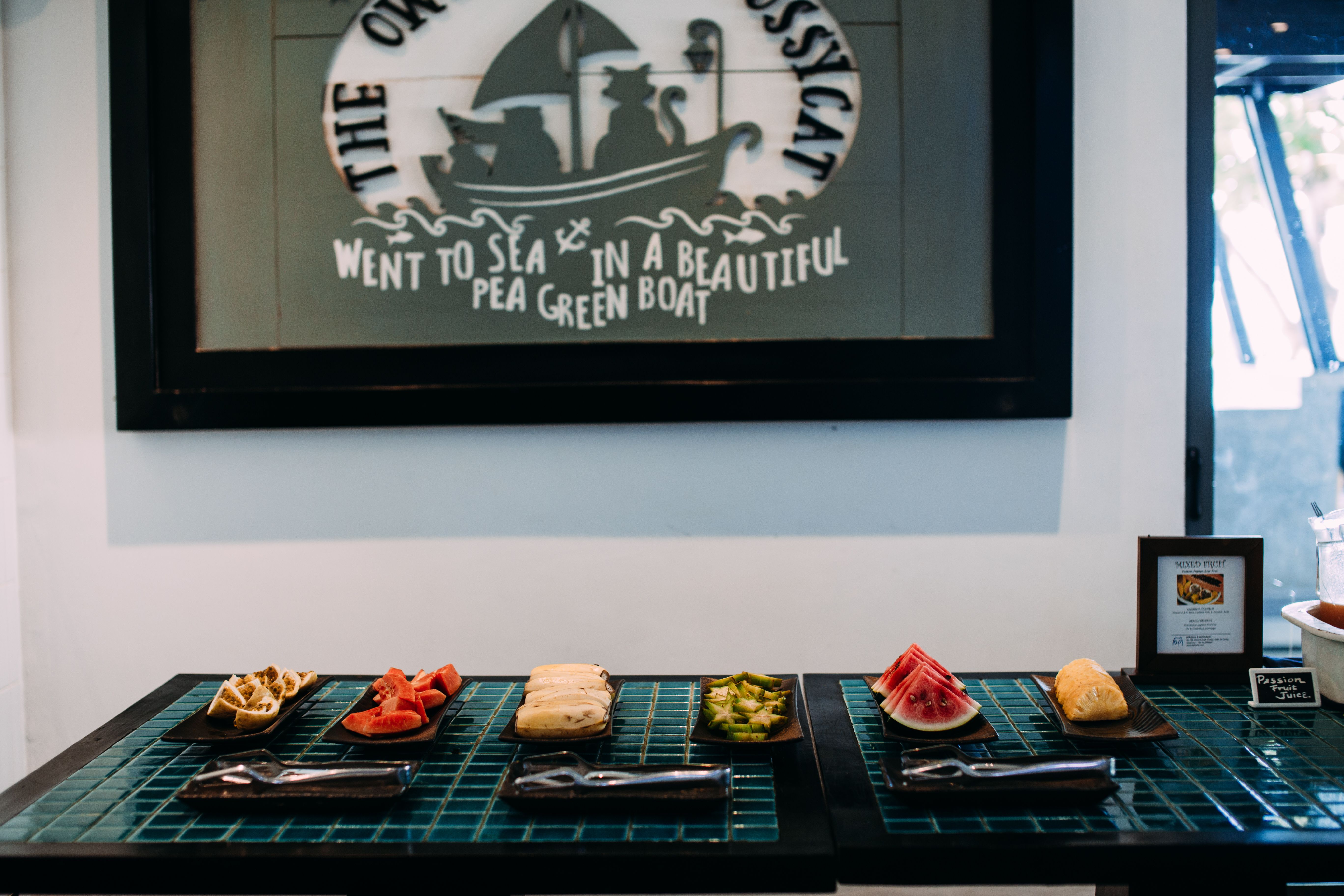A vibrant assortment of sliced fresh fruits beautifully arranged on a table in an artistic indoor setup.