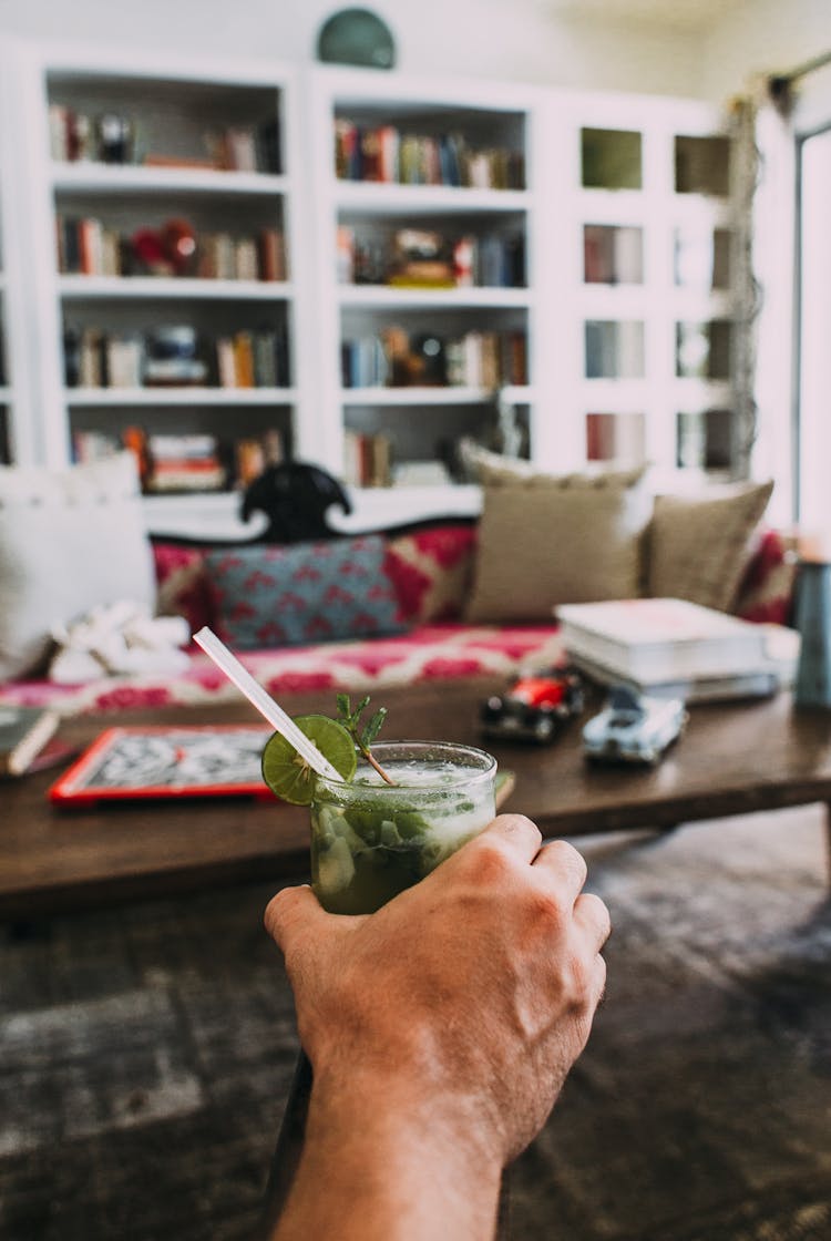 Person Holding A Cold Cocktail Drink