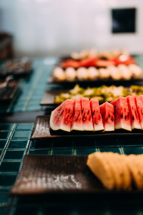 Free Vibrant slices of watermelon neatly arranged on a stylish tray, perfect for summer refreshment. Stock Photo
