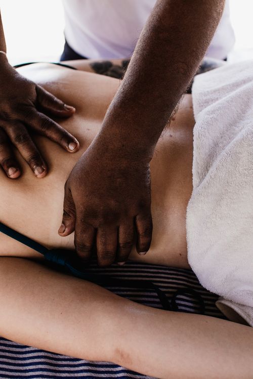 Free Close-up of a massage therapist performing a relaxing body treatment indoors. Stock Photo