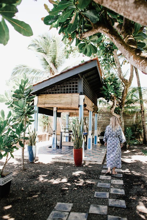 A Woman Wearing a Robe Walking Towards a Gazebo