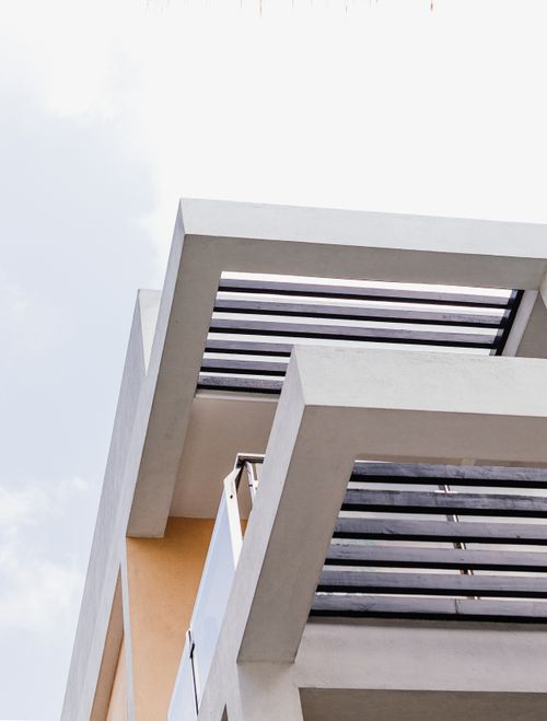 Free Contemporary building balcony with steel beams against a bright sky, showcasing modern architecture. Stock Photo