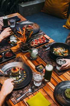 Delicious gourmet meals and drinks on a rustic dining table, perfect for culinary enthusiasts.