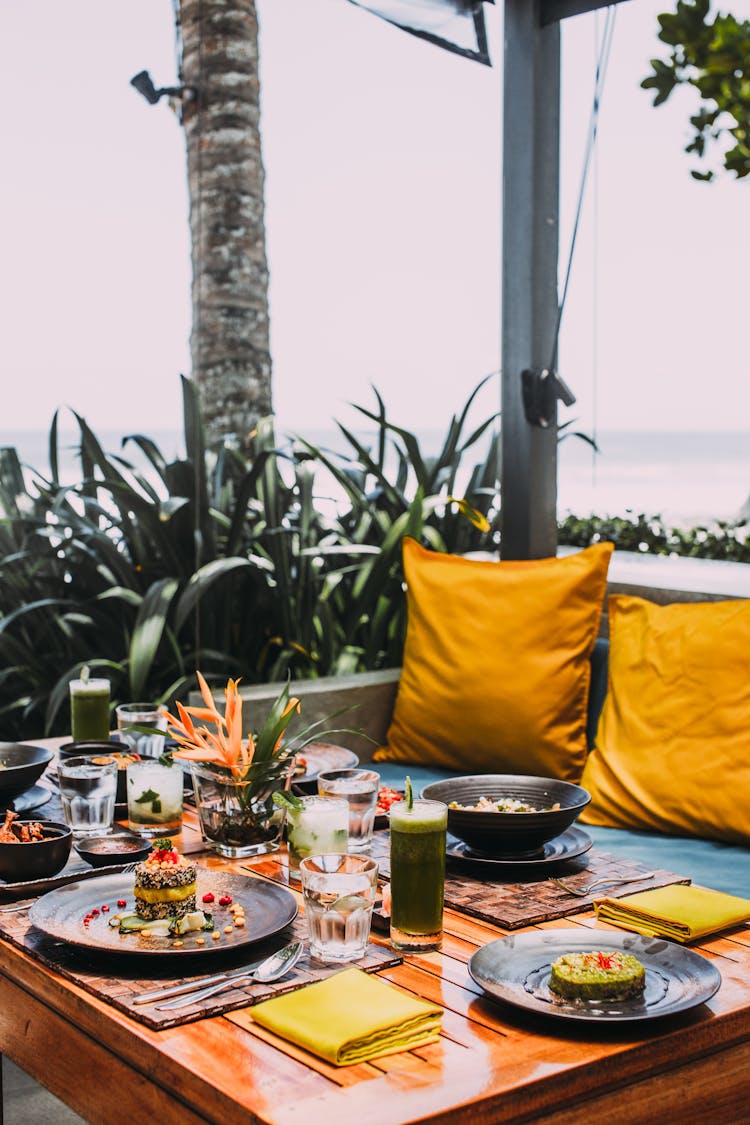 Variety Of Dishes And Beverages On Wooden Table