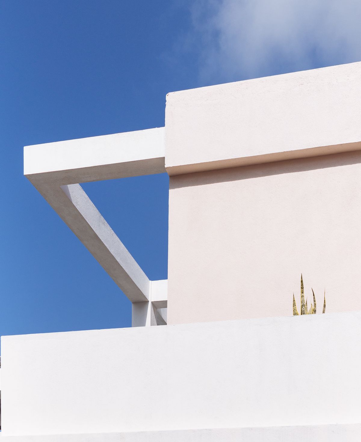 White residential building against a blue sky
