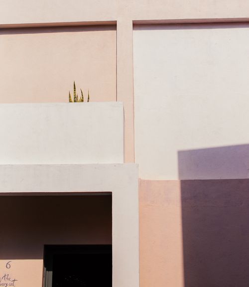 Free Modern minimalist exterior featuring clean lines and pastel colors on concrete walls. Stock Photo