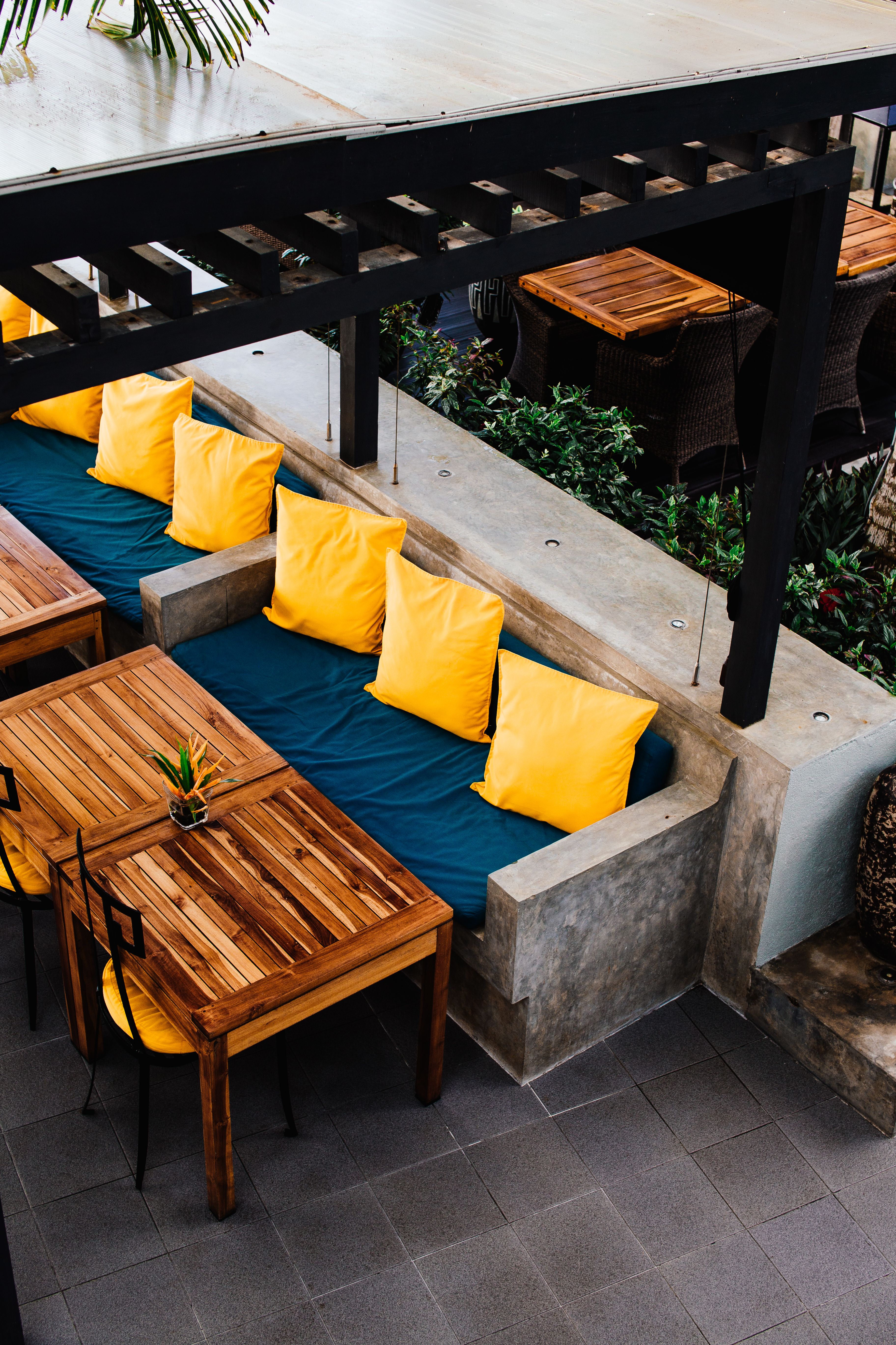 Outdoor entertaining area with built-in concrete bench seating under a pergola