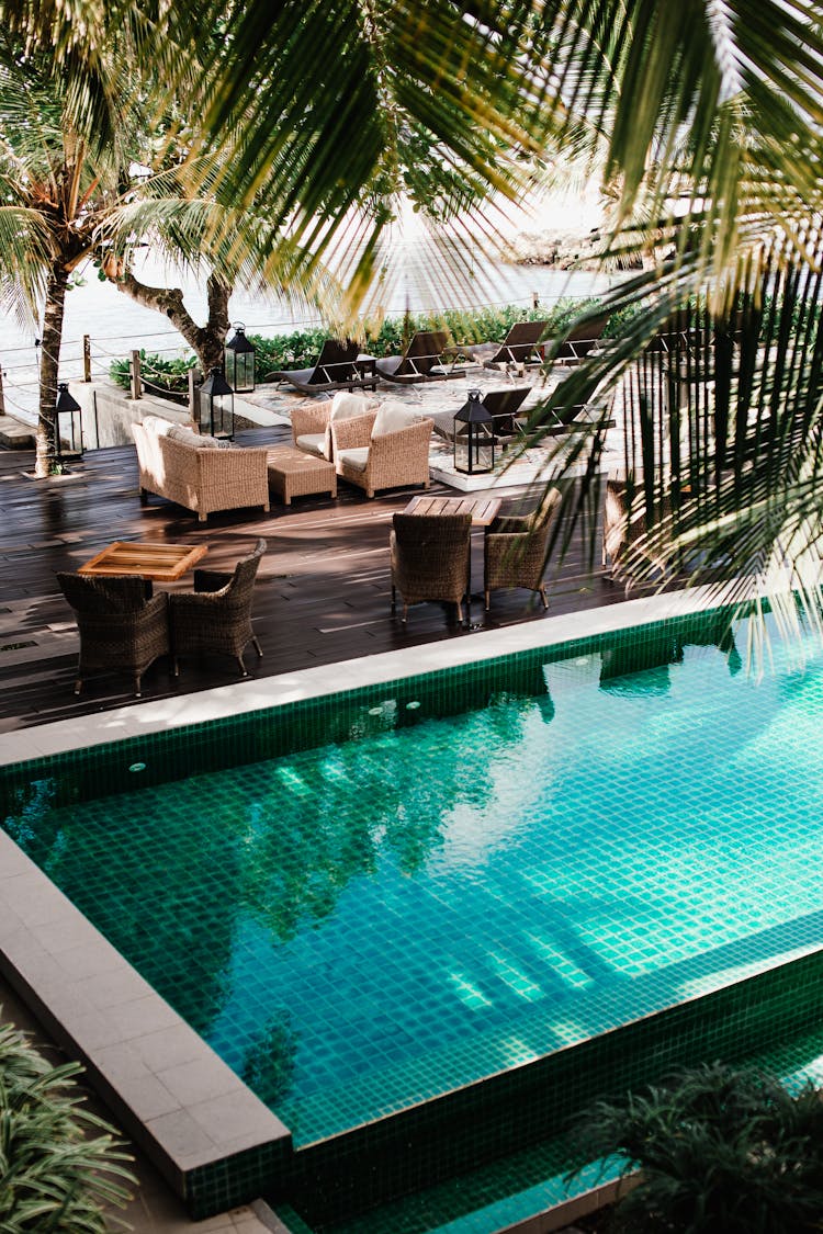 A Swimming Pool Near Tables And Chairs