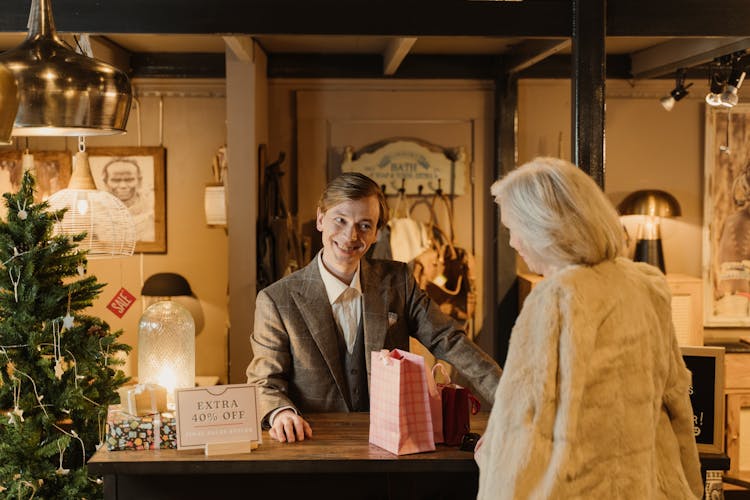 A Salesman Smiling At The Person