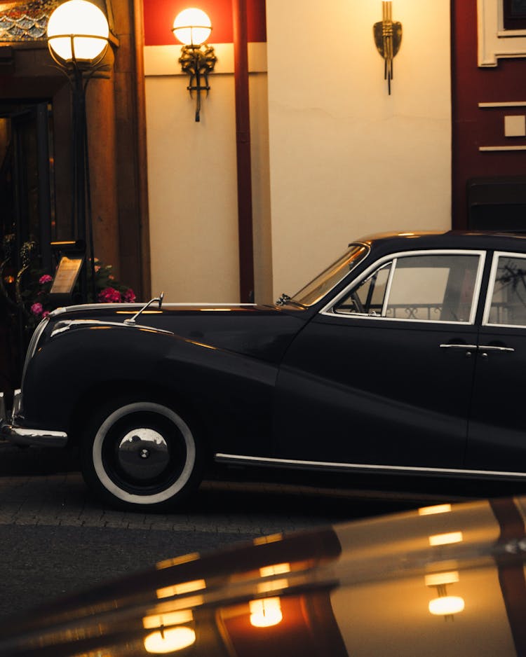 Luxury Retro Car Parked Near Modern Building At Night