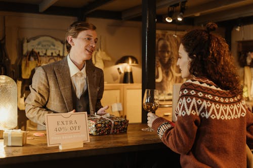 Woman Talking to the Man in the Counter 