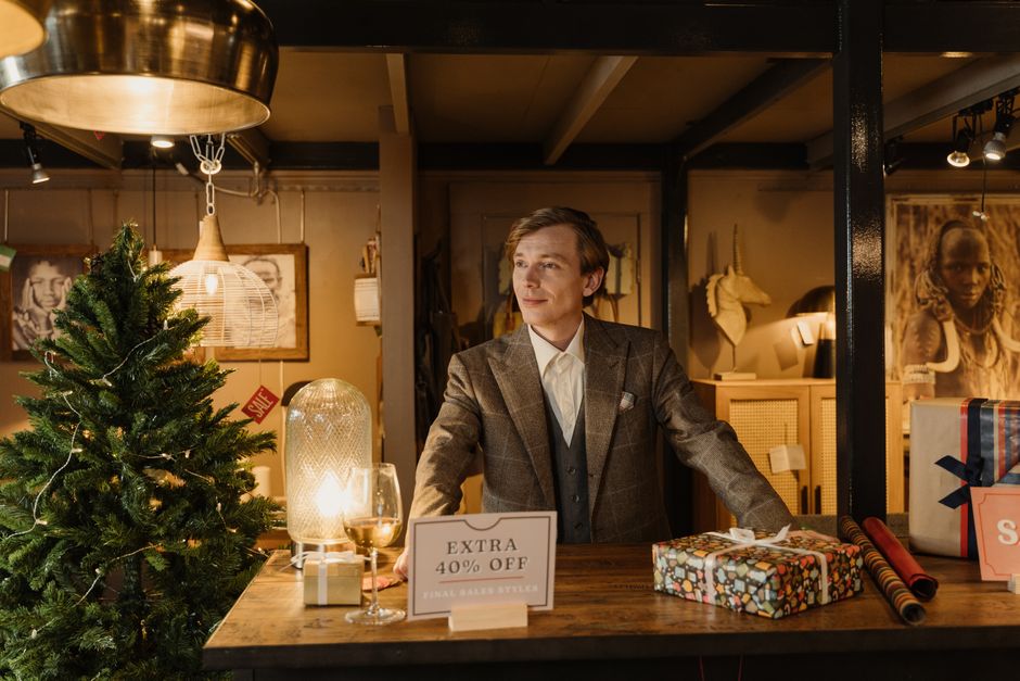 A sophisticated store display with gifts, a Christmas tree, and a 40% off sale sign.
