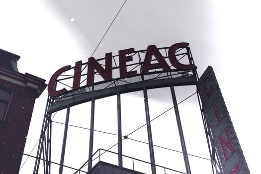 Classic vintage cinema sign on a snowy day in Amsterdam, Netherlands.
