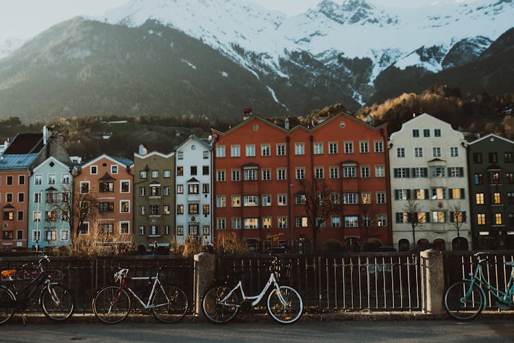 Bicycles Parked Beside A Metal Fence