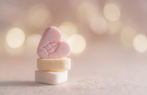 Free Three Beige, Yellow, and Pink Heart Marshmallows Stock Photo