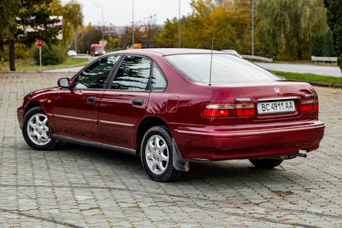 Free A Red Honda Car Parked in Pavement Stock Photo