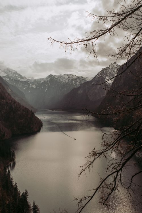 Free A serene winter scene of Königssee lake surrounded by snow-capped mountains, perfect for nature lovers. Stock Photo