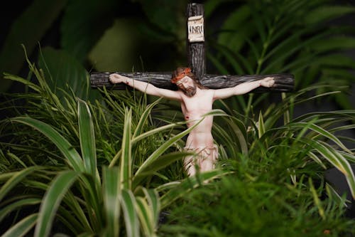 Free Crucifix on Leaves Stock Photo