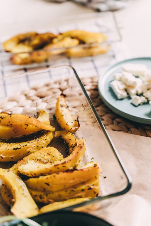 Free Deliciously roasted herb-seasoned potatoes in a glass dish, perfect for dinner. Stock Photo