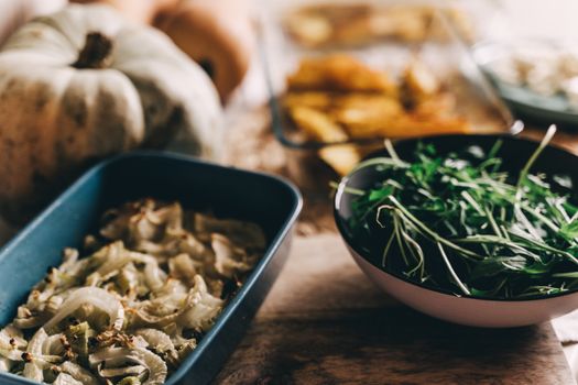 A cozy vegan meal featuring roasted vegetables and fresh greens, perfect for an autumn dinner table.