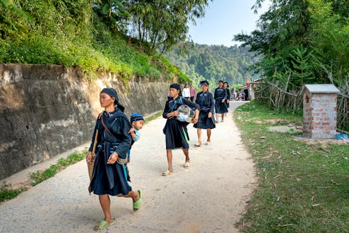 Group of Asian female farmworkers walking in countryside