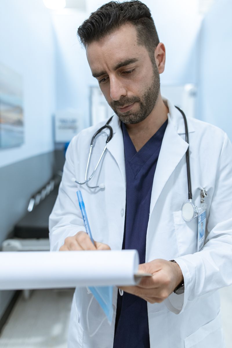 Healthcare provider reviewing patient insurance paperwork representing Medicare chiropractic coverage