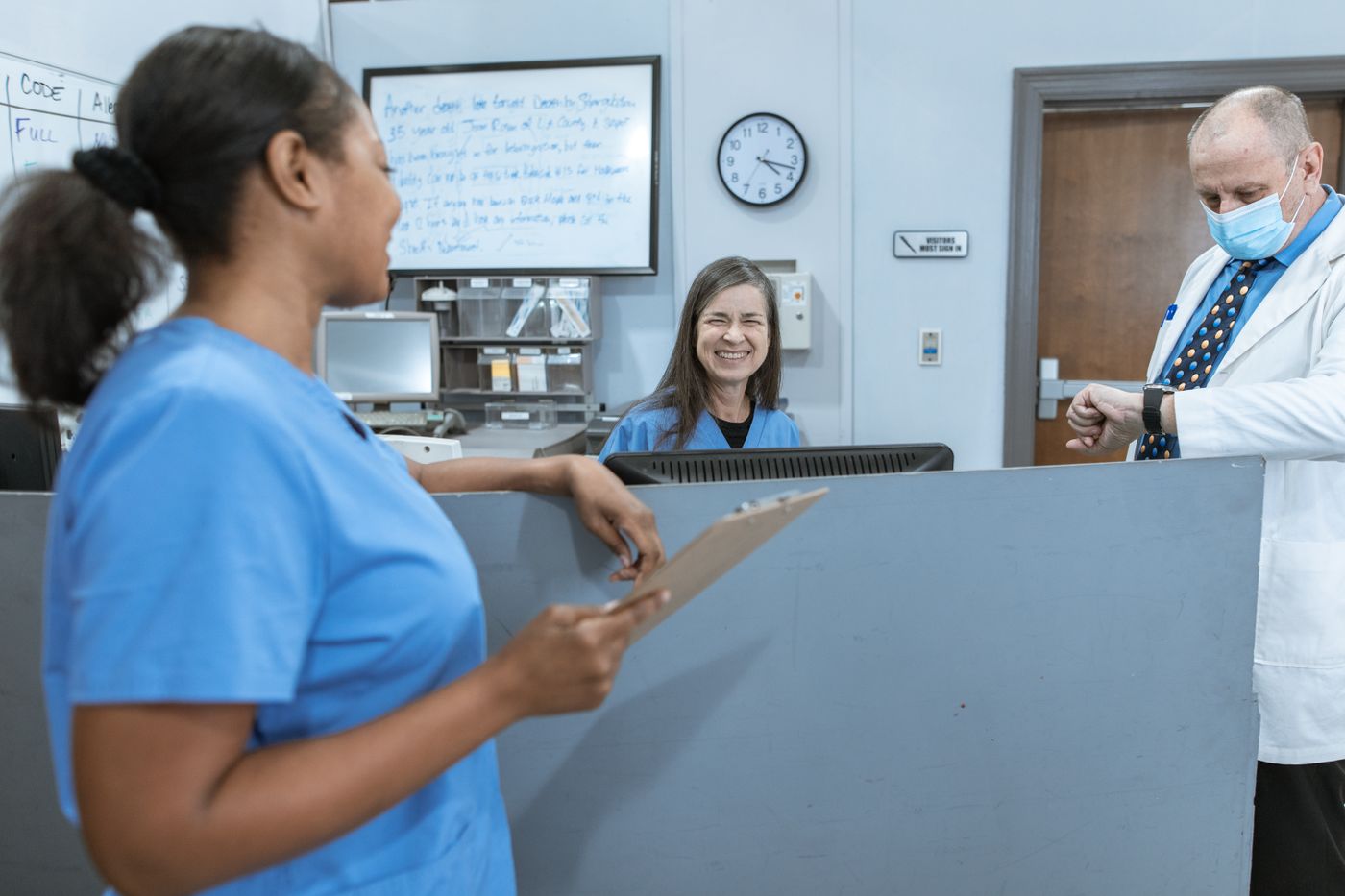 Two smiling nurses sharing a moment together